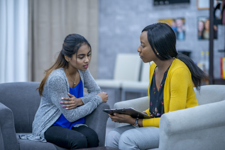 A Project Recovery team member discussing a substance abuse treatment plan with a patient