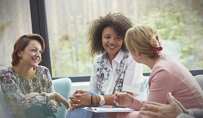 Three women having a discussion sitting down